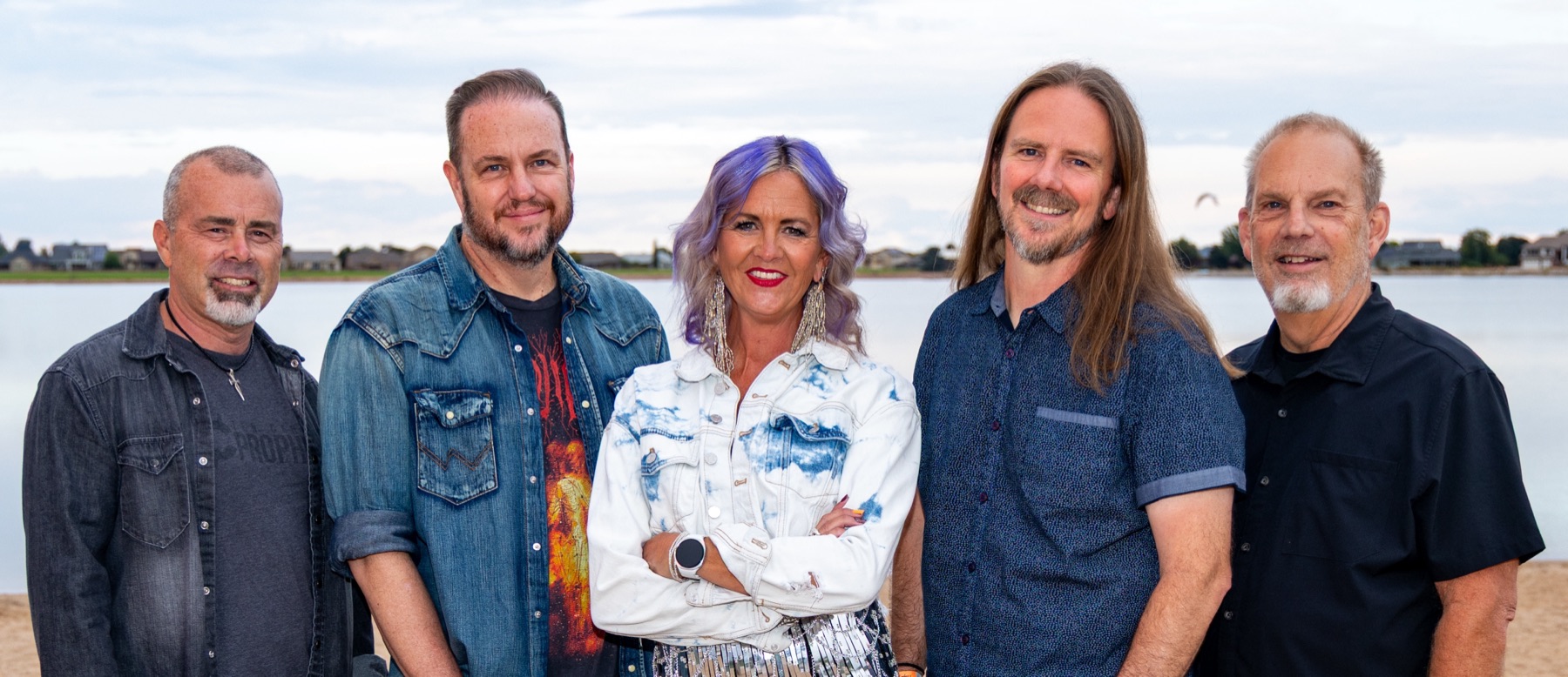 The five members of Ten Cent Prophet standing by a lake